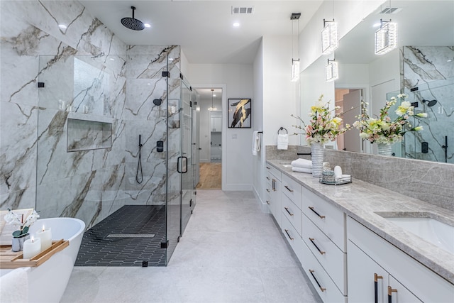 bathroom featuring vanity and plus walk in shower