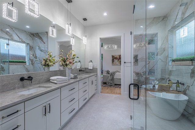 bathroom with vanity, independent shower and bath, and wood-type flooring