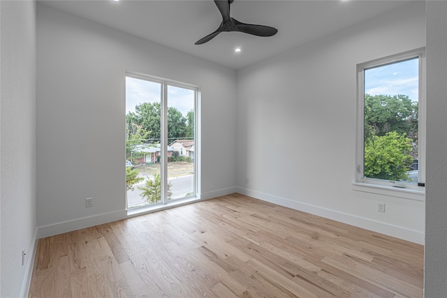 empty room with light wood-type flooring and ceiling fan