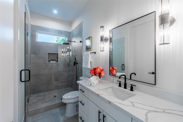 bathroom with vanity, toilet, and walk in shower