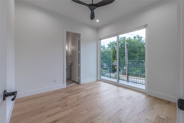 empty room with ceiling fan and light hardwood / wood-style flooring