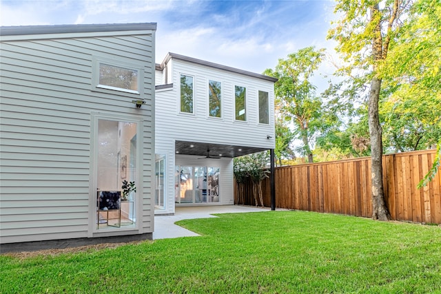 back of property featuring a patio and a yard