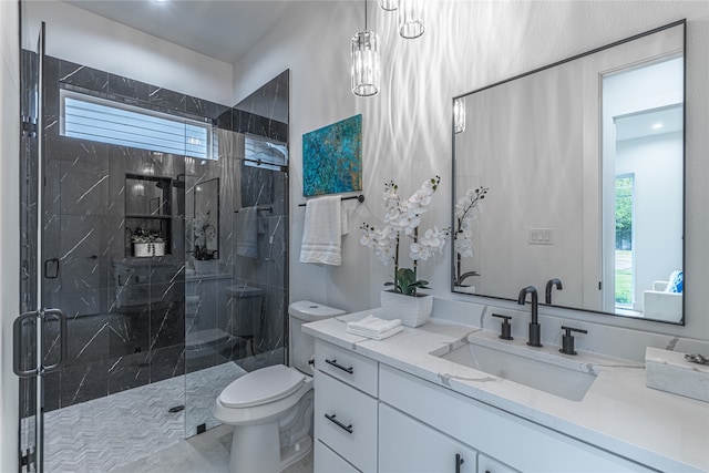 bathroom featuring toilet, a shower with door, vanity, and a wealth of natural light