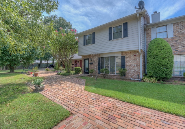 view of front of property with a front yard and a patio area