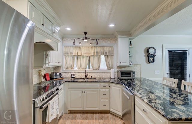 kitchen with backsplash, stainless steel appliances, light hardwood / wood-style floors, and sink