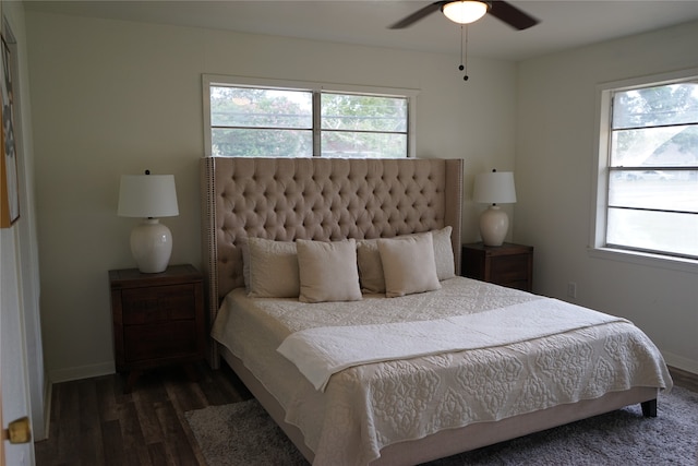 bedroom featuring multiple windows, dark hardwood / wood-style flooring, and ceiling fan