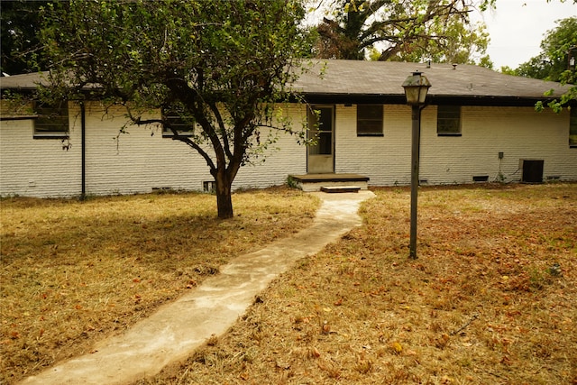 rear view of house featuring a yard