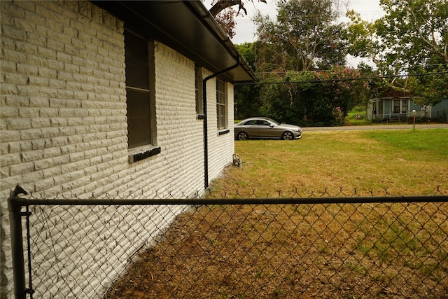 view of side of property with a lawn