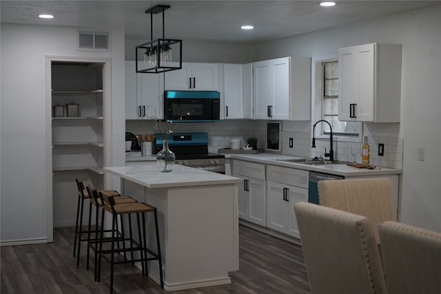 kitchen featuring dark wood-type flooring, white cabinets, stainless steel appliances, and sink