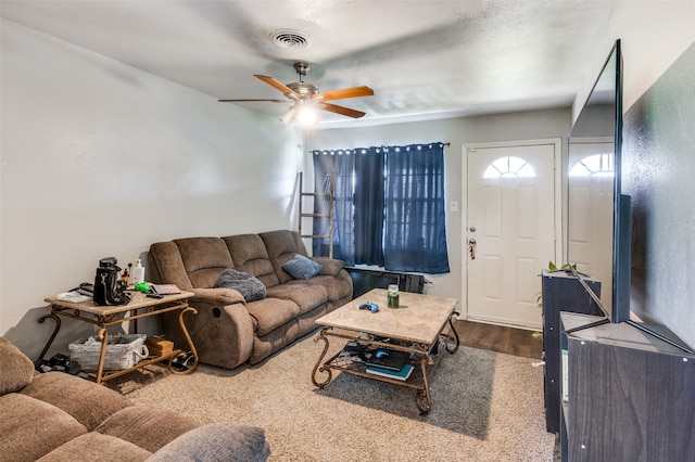 living room with wood-type flooring and ceiling fan