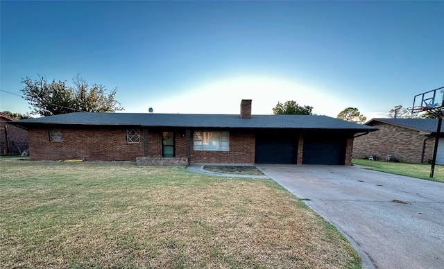 ranch-style house with a garage and a front lawn