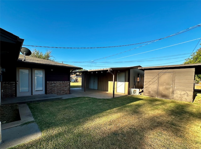 view of yard with a shed and a patio