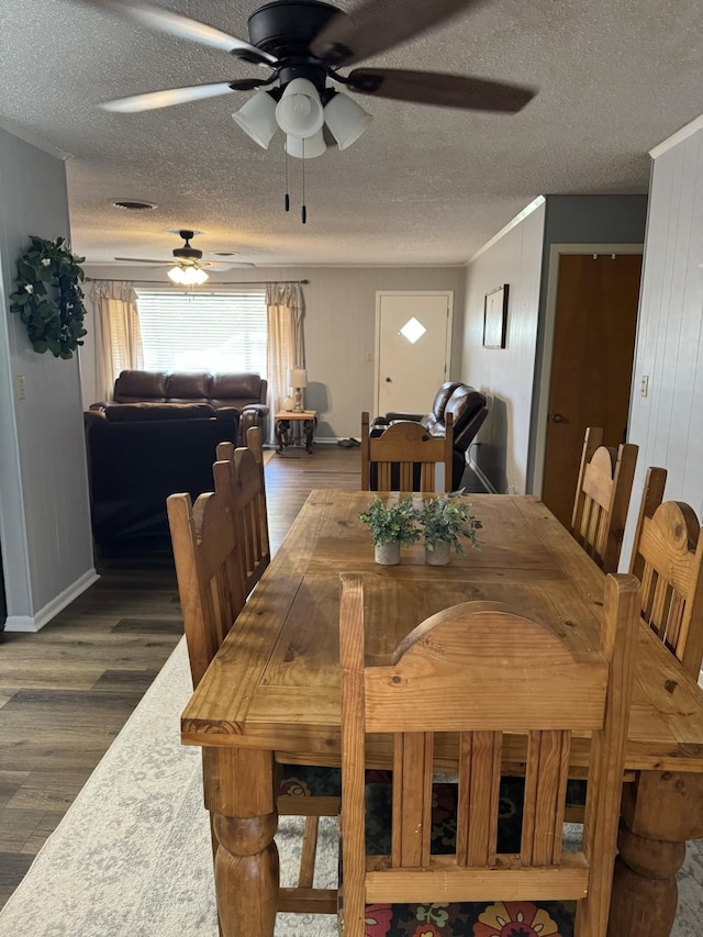 dining space featuring ceiling fan, a textured ceiling, and dark hardwood / wood-style floors