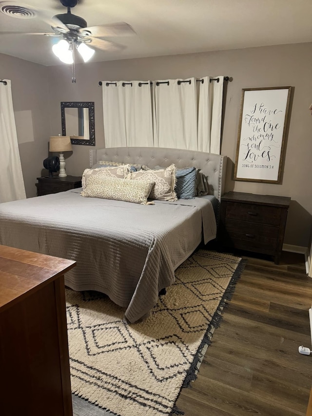 bedroom with ceiling fan and dark hardwood / wood-style flooring