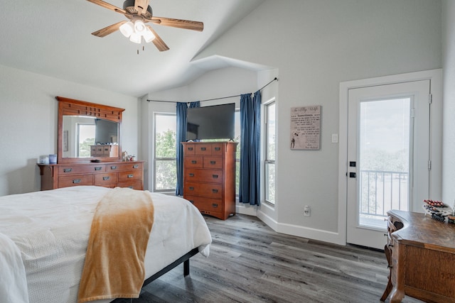 bedroom featuring access to outside, ceiling fan, wood-type flooring, and vaulted ceiling