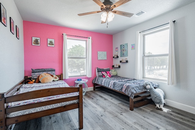 bedroom featuring ceiling fan and light hardwood / wood-style flooring