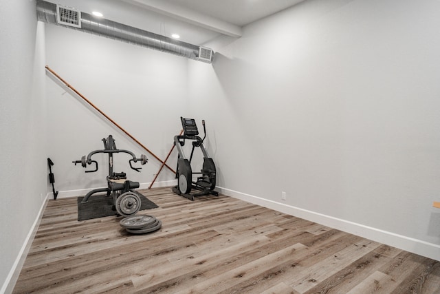 exercise room featuring wood-type flooring