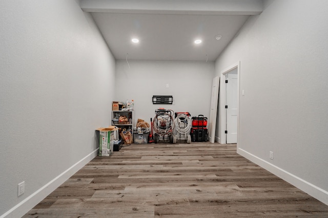 interior space with beam ceiling and light hardwood / wood-style floors