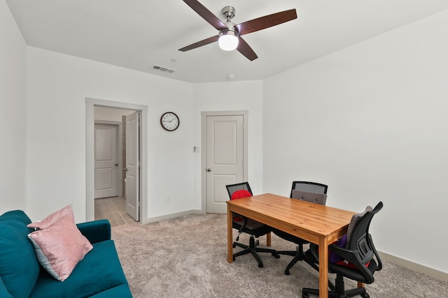 home office with light carpet and ceiling fan