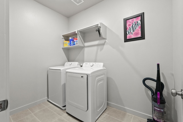 laundry room featuring light tile patterned flooring and washing machine and clothes dryer