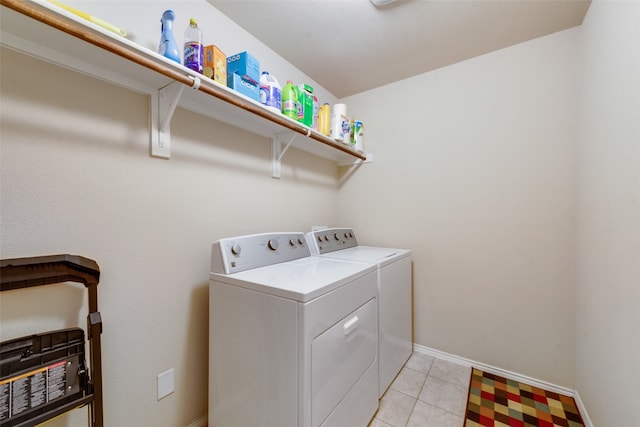 clothes washing area featuring separate washer and dryer and light tile patterned floors