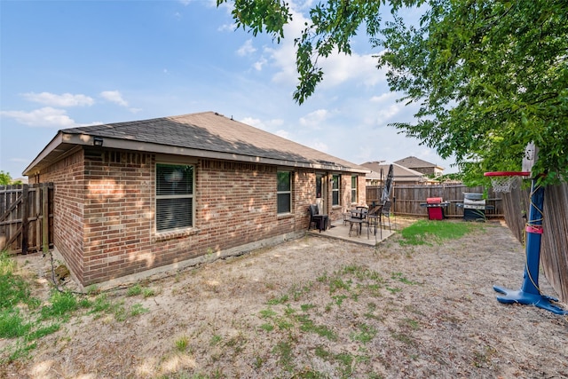 2512 Saldana Dr, Fate, TX 75189 - rear view of property with brick siding, a fenced backyard, roof with shingles, and a patio