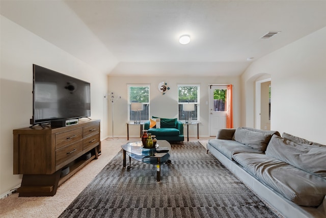 carpeted living room with vaulted ceiling