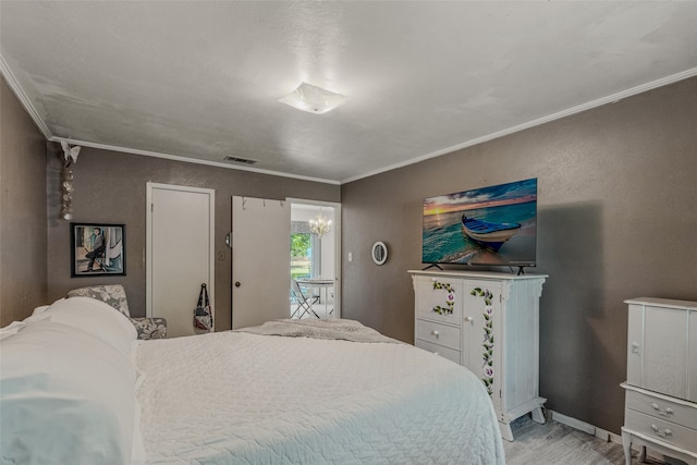 bedroom with light hardwood / wood-style floors and crown molding