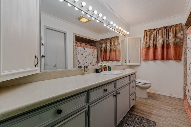 bathroom featuring toilet, walk in shower, crown molding, vanity, and wood-type flooring