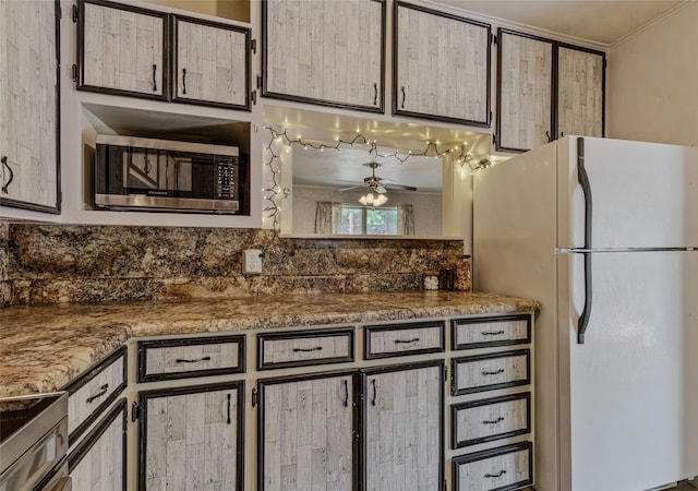 kitchen featuring stone countertops, ceiling fan, ornamental molding, and appliances with stainless steel finishes