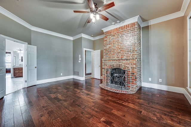 unfurnished living room featuring ceiling fan, ornamental molding, hardwood / wood-style floors, and a brick fireplace