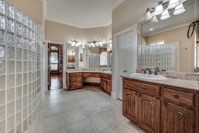 bathroom with crown molding, vanity, tile patterned floors, and walk in shower