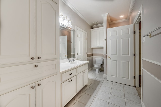 bathroom with tile patterned flooring, toilet, ornamental molding, and vanity