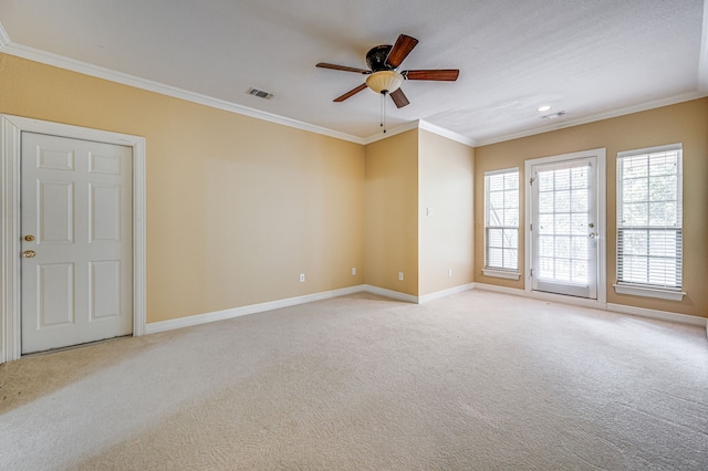 carpeted spare room with ornamental molding and ceiling fan