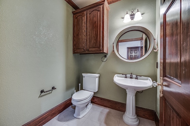 bathroom featuring toilet and tile patterned flooring