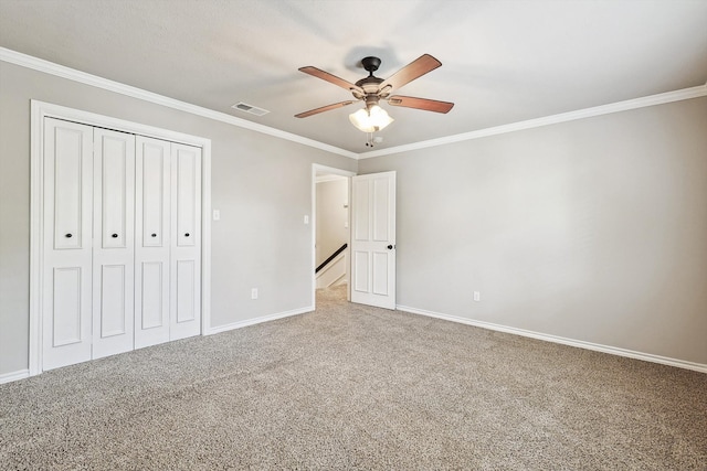 unfurnished bedroom with crown molding, light colored carpet, and ceiling fan