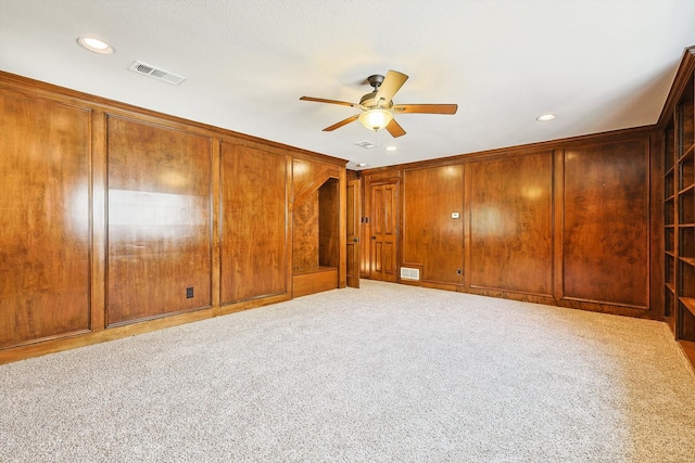 unfurnished room with ceiling fan and carpet