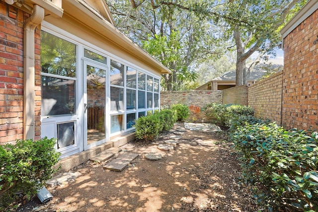 view of patio featuring a sunroom