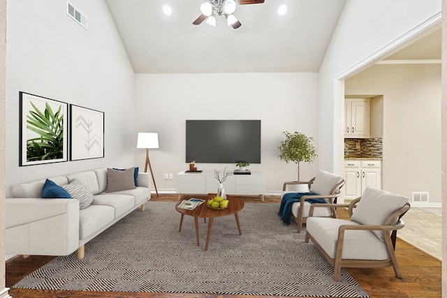 living room with lofted ceiling, hardwood / wood-style flooring, and ceiling fan