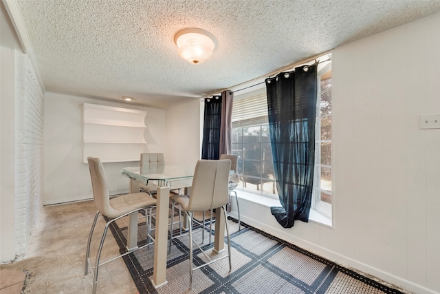 dining room featuring a textured ceiling