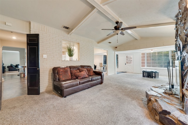 living room featuring lofted ceiling with beams, ceiling fan, and carpet