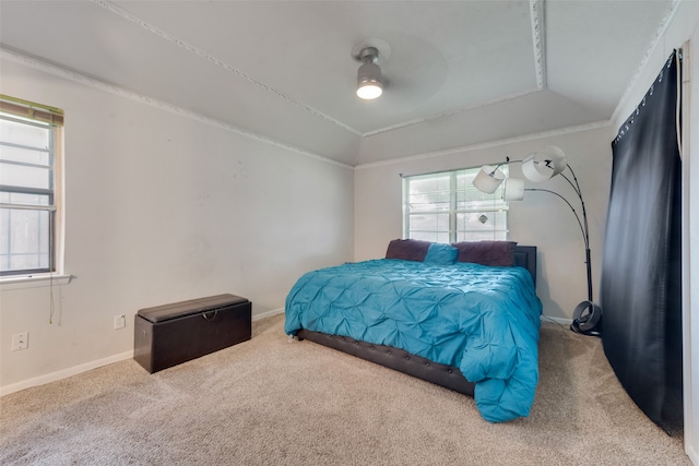 bedroom with lofted ceiling, ceiling fan, carpet, and crown molding