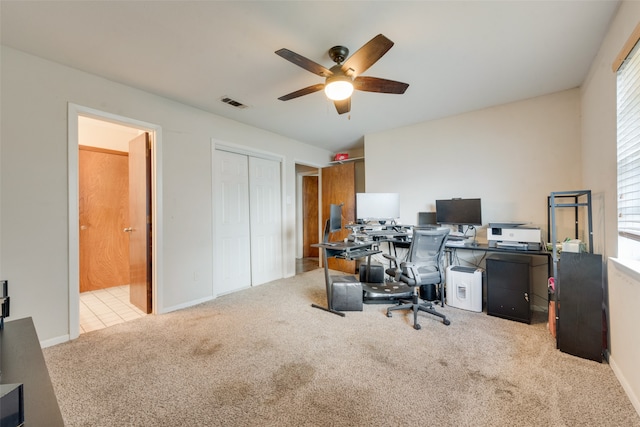 home office with ceiling fan and light carpet