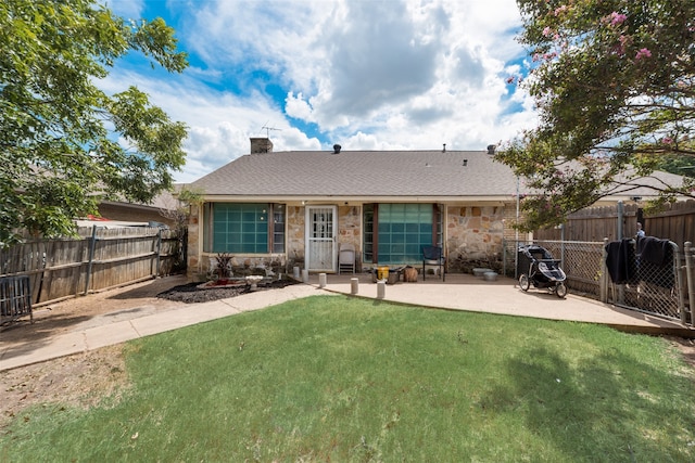 back of property with a lawn and a patio area