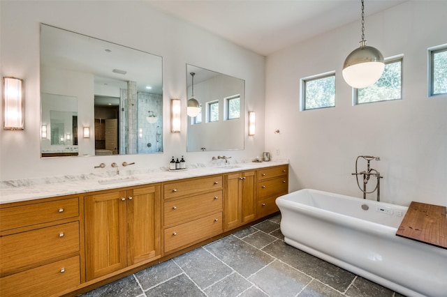 bathroom featuring vanity and independent shower and bath