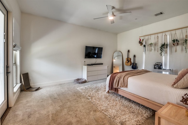 bedroom featuring ceiling fan, multiple windows, and carpet