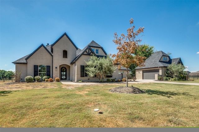 view of front of home featuring a garage and a front lawn