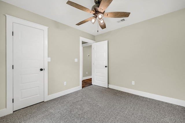 unfurnished bedroom with carpet, ceiling fan, and a closet