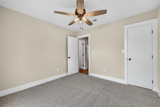 unfurnished bedroom featuring ceiling fan and carpet floors