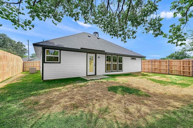 back of house with cooling unit, a yard, and a patio